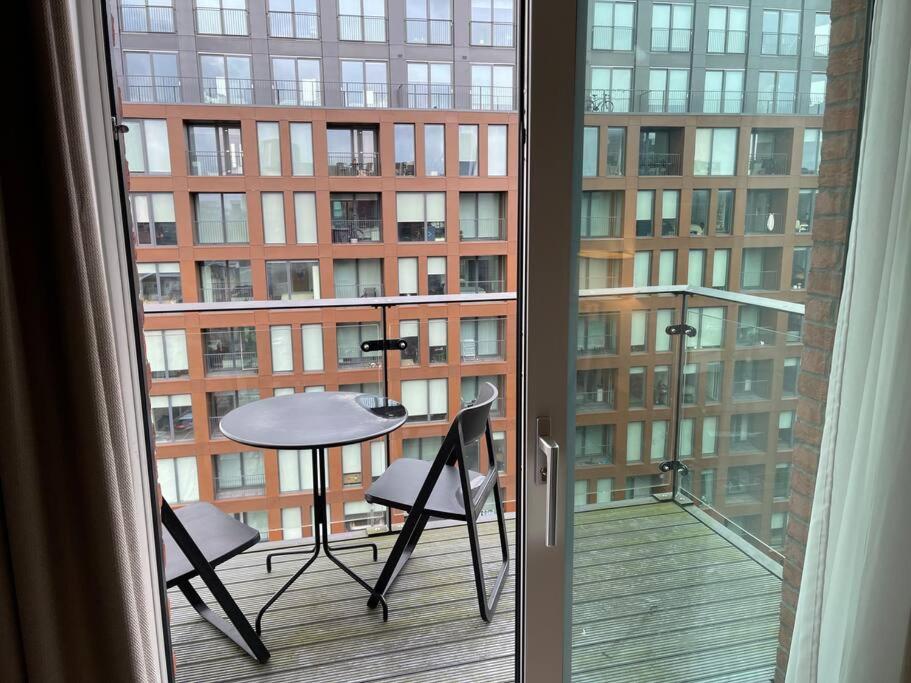 a balcony with a table and chairs in a building at 2 bedroom Apartment in Manchester