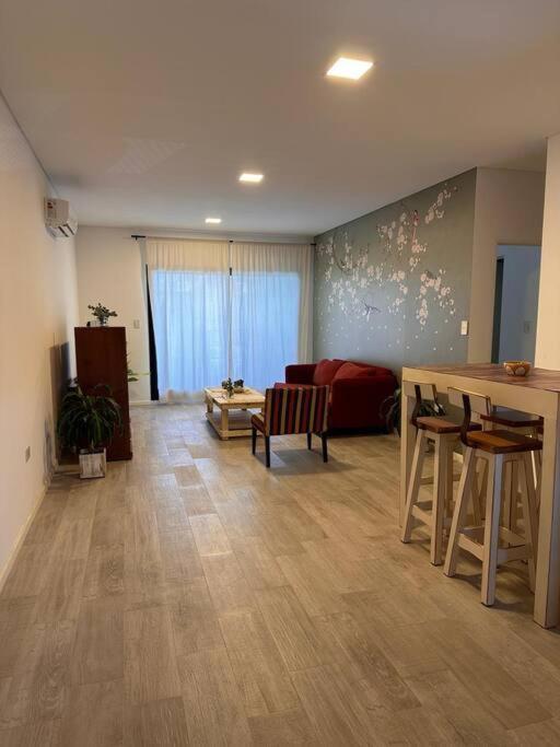 a living room with a couch and a table at Departamento Amoblado de lujo! in Pilar