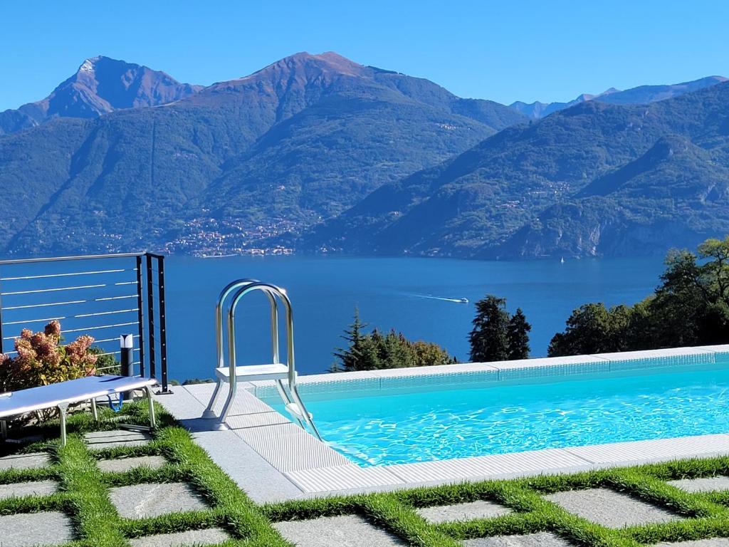 a swimming pool with a view of a lake and mountains at PARADISE VILLA VISTA LAGO DI COMO A MENAGGIO in Menaggio