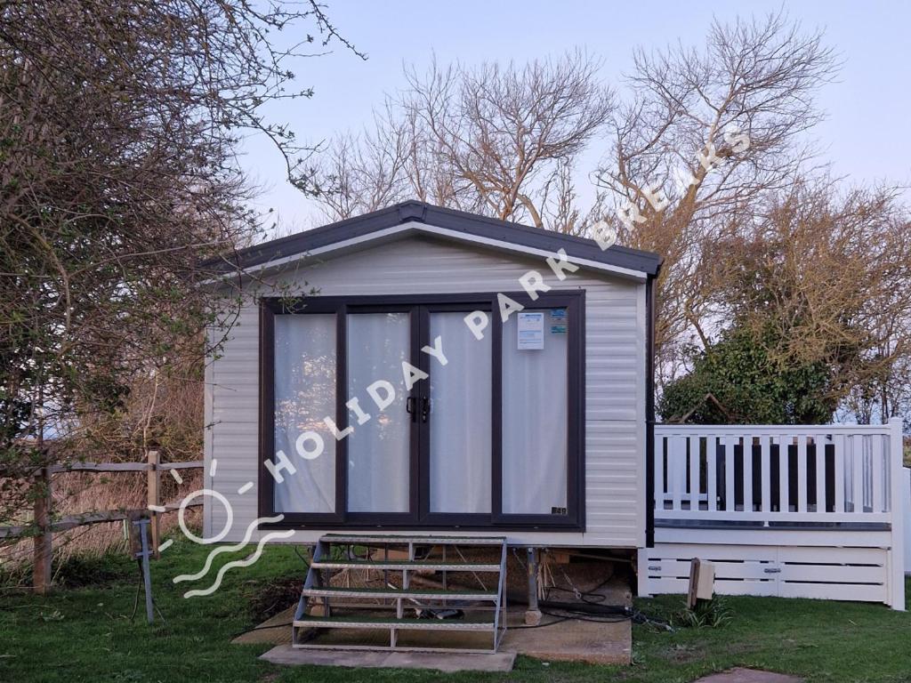a tiny house with a window on the side of it at 2 bed Hideaway @ Seal Bay Resort in Selsey