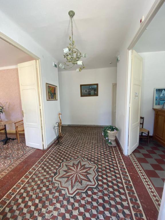 an empty room with a rug on the floor at HOTEL LE FLOREAL in Le Soler