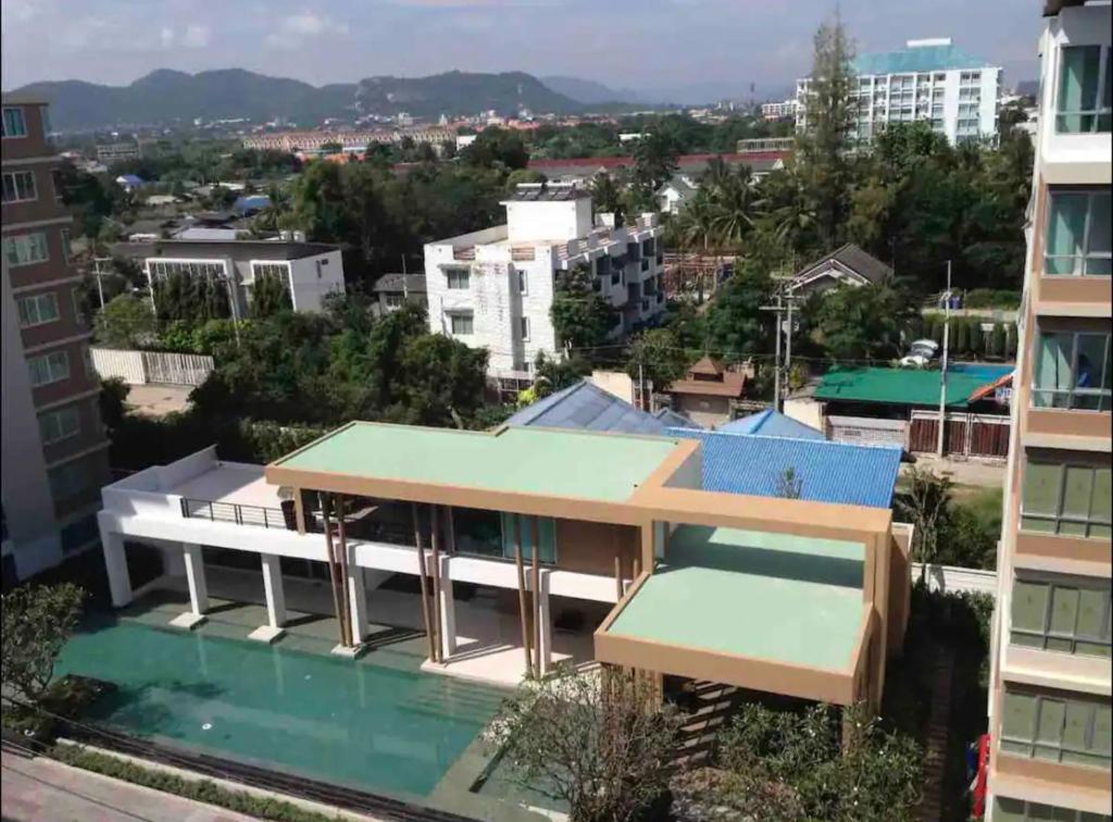 a building with a swimming pool in a city at "500m from Beach Modern Residence" in Hua Hin