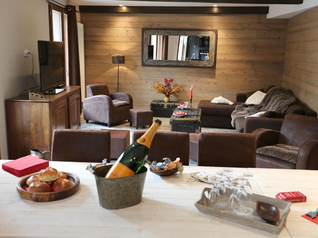 a living room with a bottle of wine on a table at Appartement Valloire, 4 pièces, 9 personnes - FR-1-263-215 in Valloire