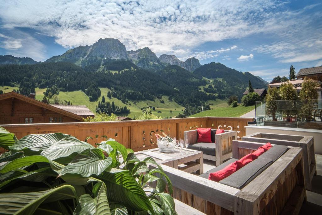 a patio with a view of a mountain at Hôtel de Rougemont & Spa in Gstaad