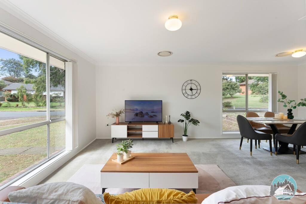 a living room with a table and a dining room at Aircabin - Marayong - Convenient - 3 Beds House in Blacktown