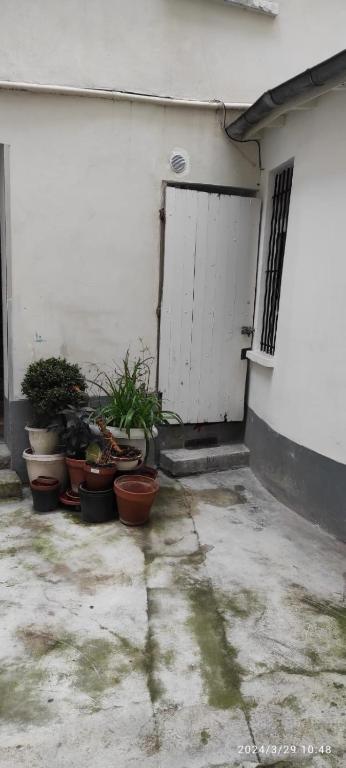 a group of potted plants in front of a garage at Studio Paris in Paris