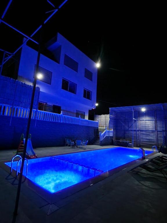 a swimming pool at night in front of a house at Amazing Villa With Large Private Swimming Pool in Tangier