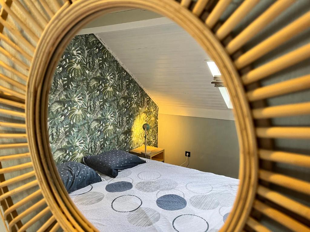 a mirror reflection of a bed in a room at Beach Bungalow Green in Middelkerke