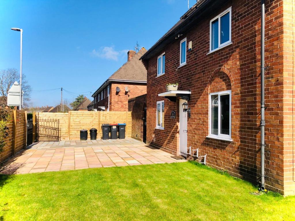 a brick house with a lawn in front of it at The Highfield Chester. in Chester