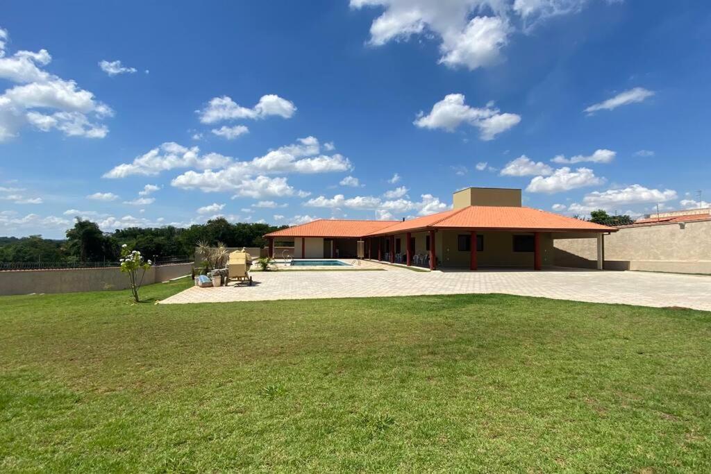 a large building with a grass yard in front of it at Chácara Mahalo’s in Sorocaba