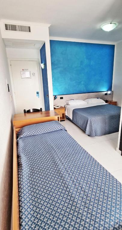 Postel nebo postele na pokoji v ubytování Hotel Blu Eden