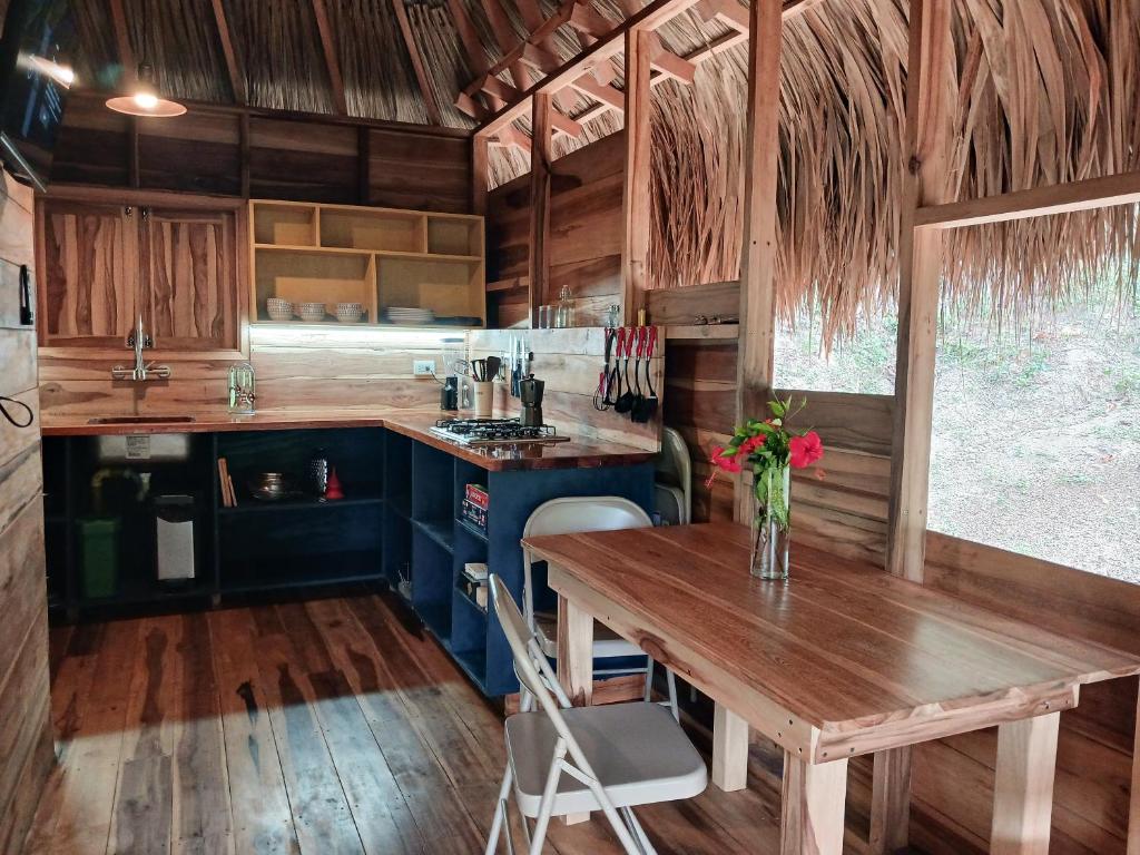 a kitchen with a wooden table and a wooden floor at Casa Sol Y Sombra in Santa Marta