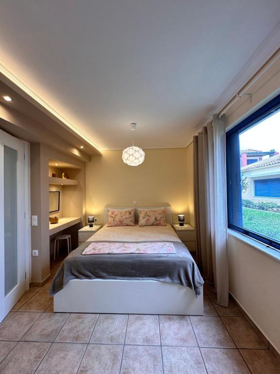 a bedroom with a large bed and a window at Simple Pleasure Verde Blu App in Barbati