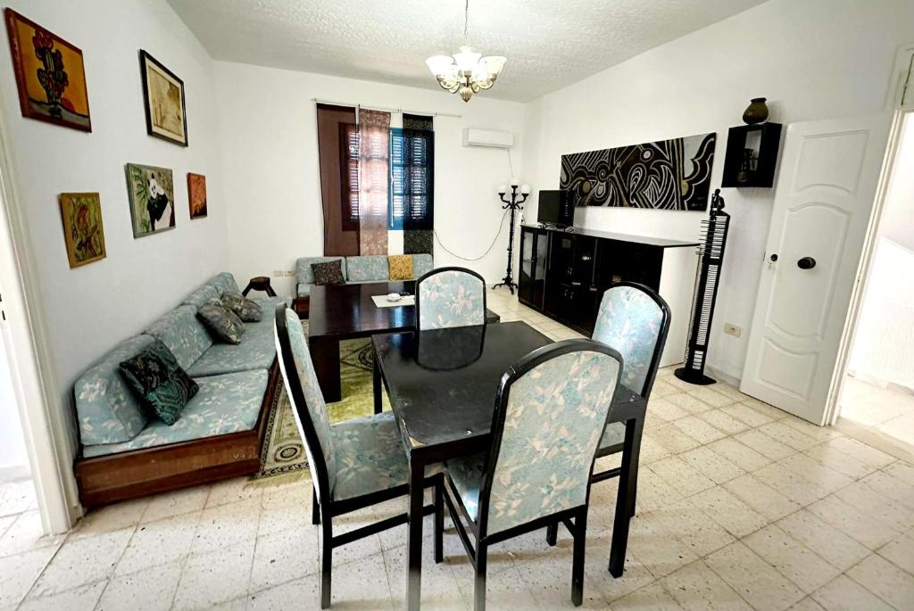 a dining room with a table and a couch at Anis in Sousse