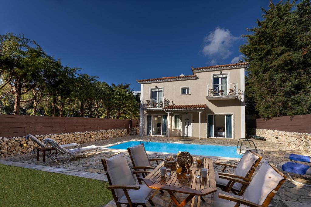 a villa with a swimming pool and a house at Villa Kataleya in Svoronata