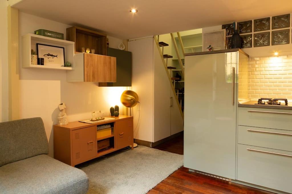 a small kitchen with a couch and a refrigerator at LaFilo Apartment 1 in Milan
