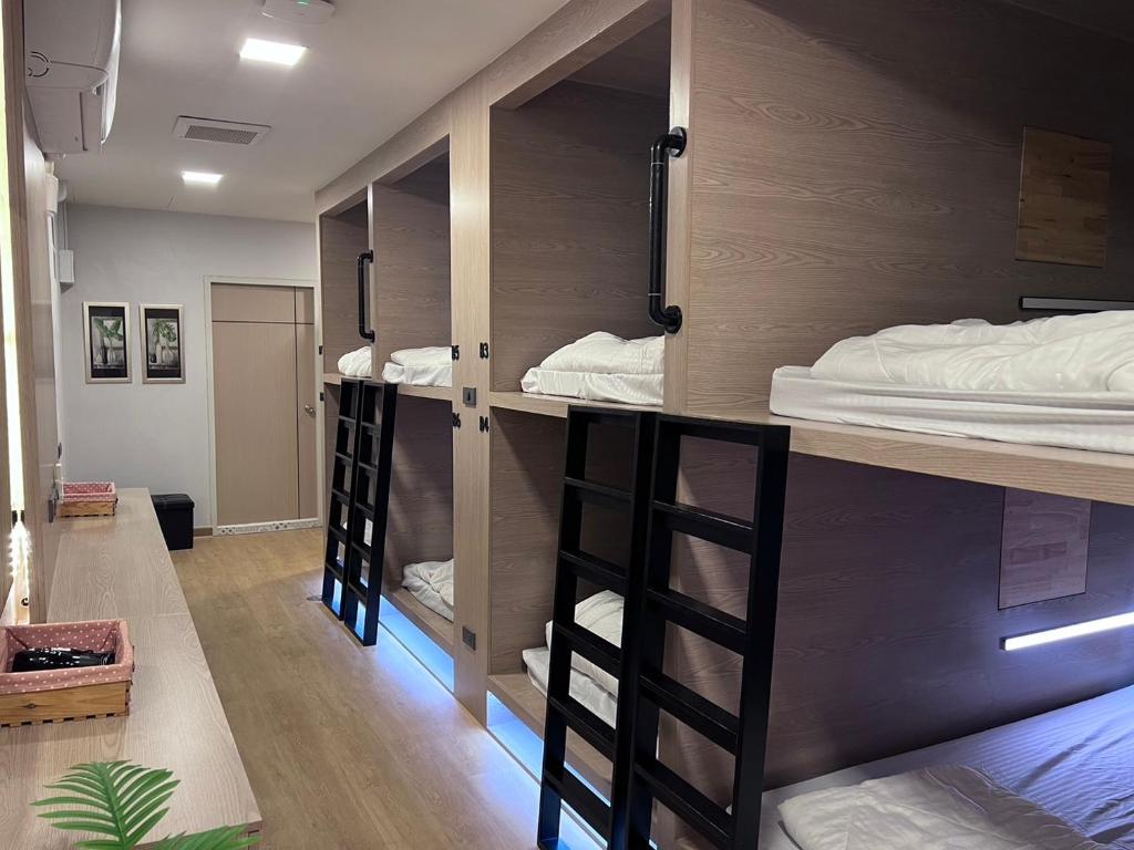 a room with bunk beds in a room at Ratchadadome hostel in Bangkok
