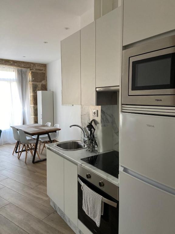 Kuchyň nebo kuchyňský kout v ubytování Reginita Apartamentos
