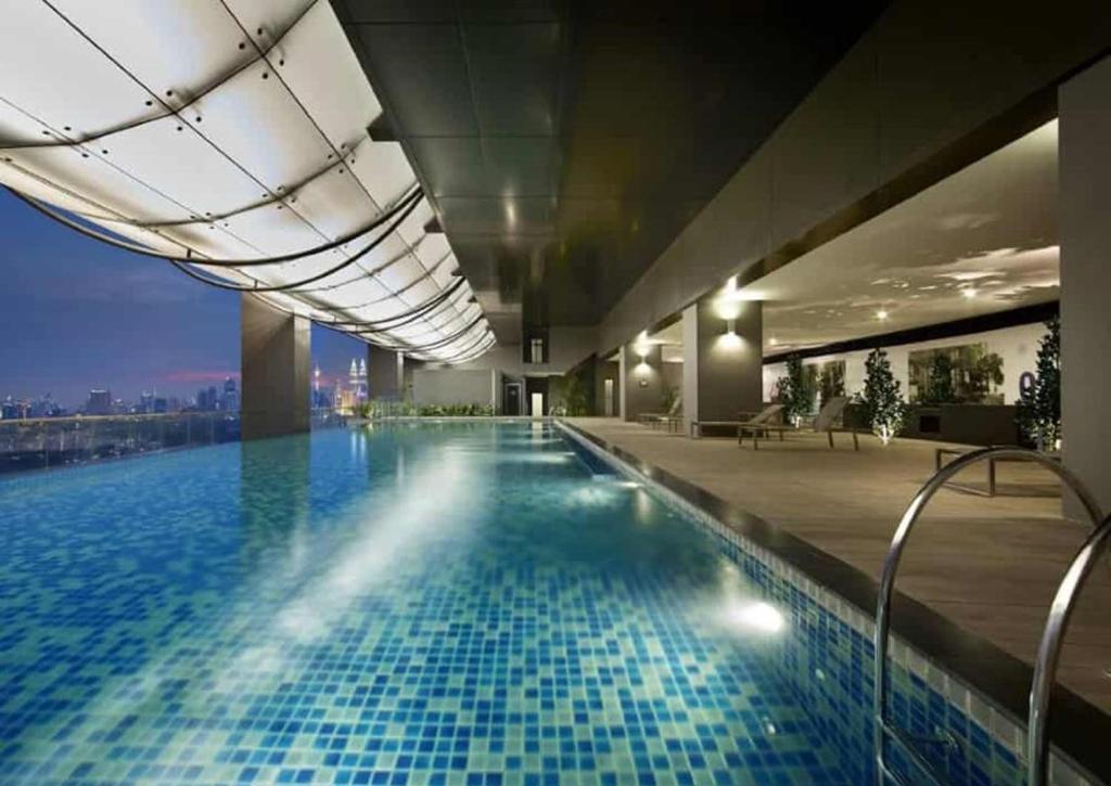 een zwembad in een gebouw met uitzicht bij M City Ampang Apartment by ICONUS in Kuala Lumpur