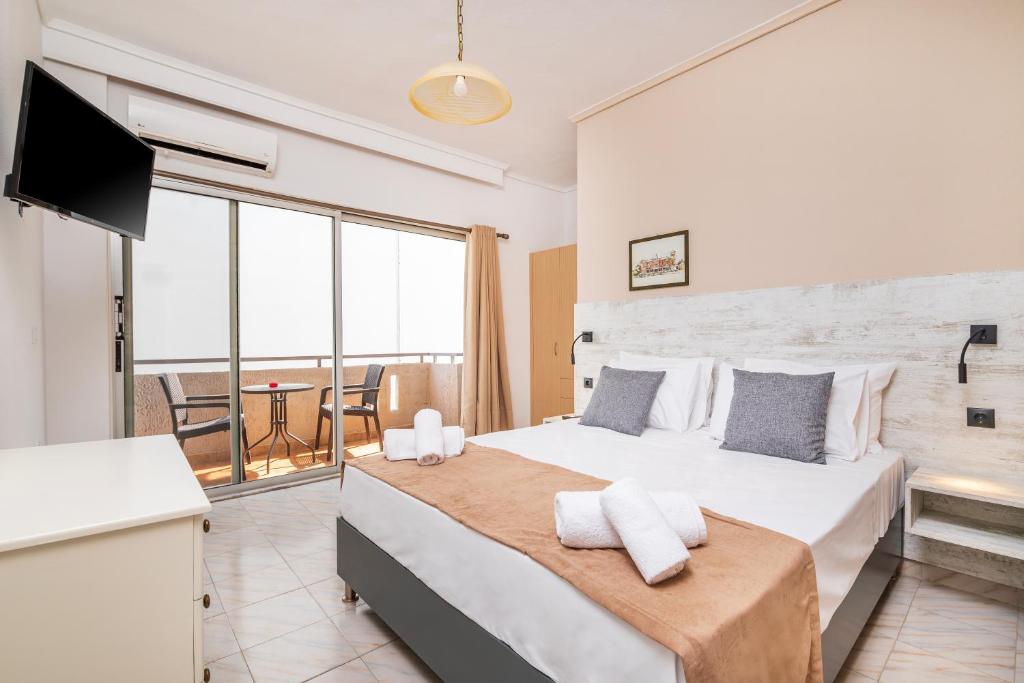 a bedroom with a large bed and a television at City Life Marina apartment No. 5 in Ampavris