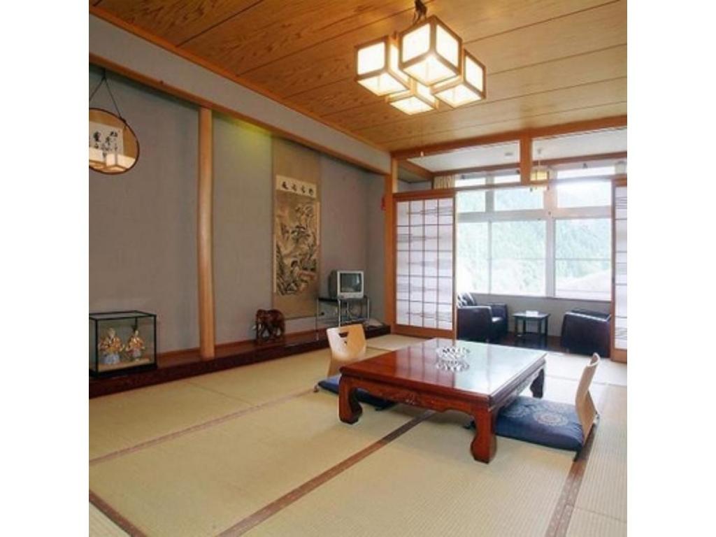 a large living room with a table and chairs at Houraku - Vacation STAY 23297v in Kamikawa