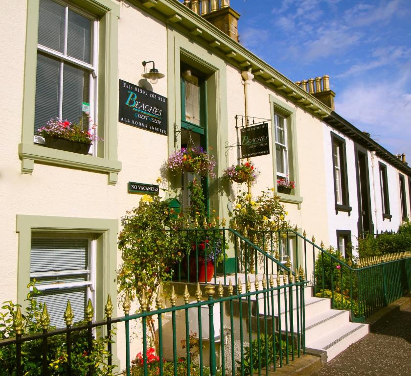 a building with flowerpots on the front of it at Beaches in Ayr