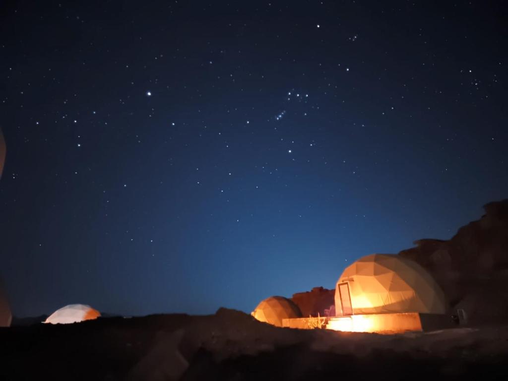 a night view of two domes in the desert at Bright stars rum camp in Wadi Rum