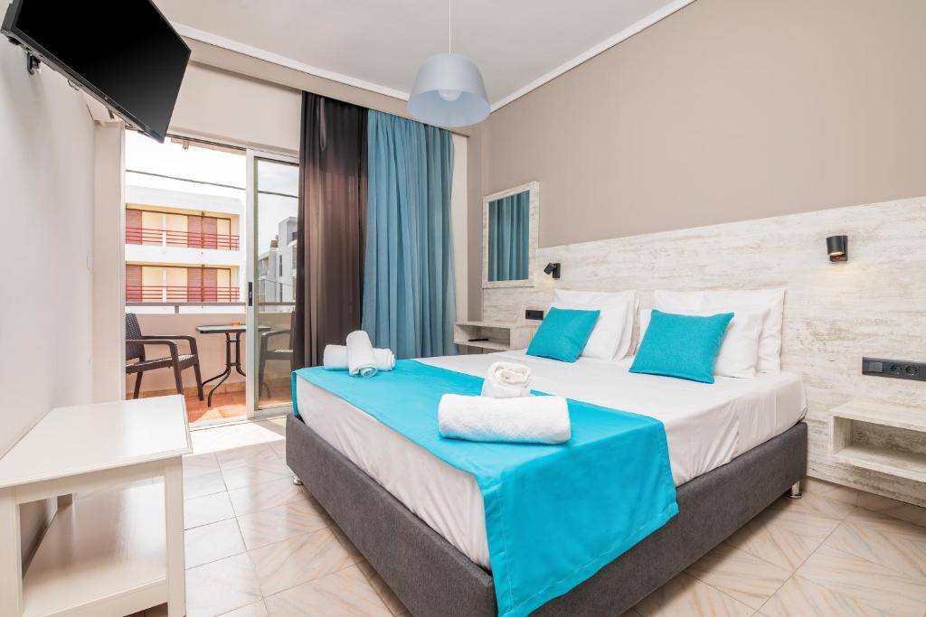 a bedroom with a large bed with blue accents at City Life Marina apartment No.22 in Ampavris