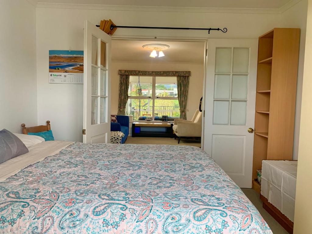 um quarto com uma cama grande e uma sala de estar em Home away from home em Christchurch