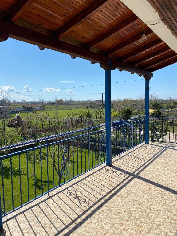 a balcony with a fence and a view of a field at Bert-House close to the sea in Lezhë