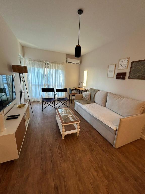 a living room with a couch and a table at San Telmo Luminoso & Cozy Ayres del Lezama in Buenos Aires