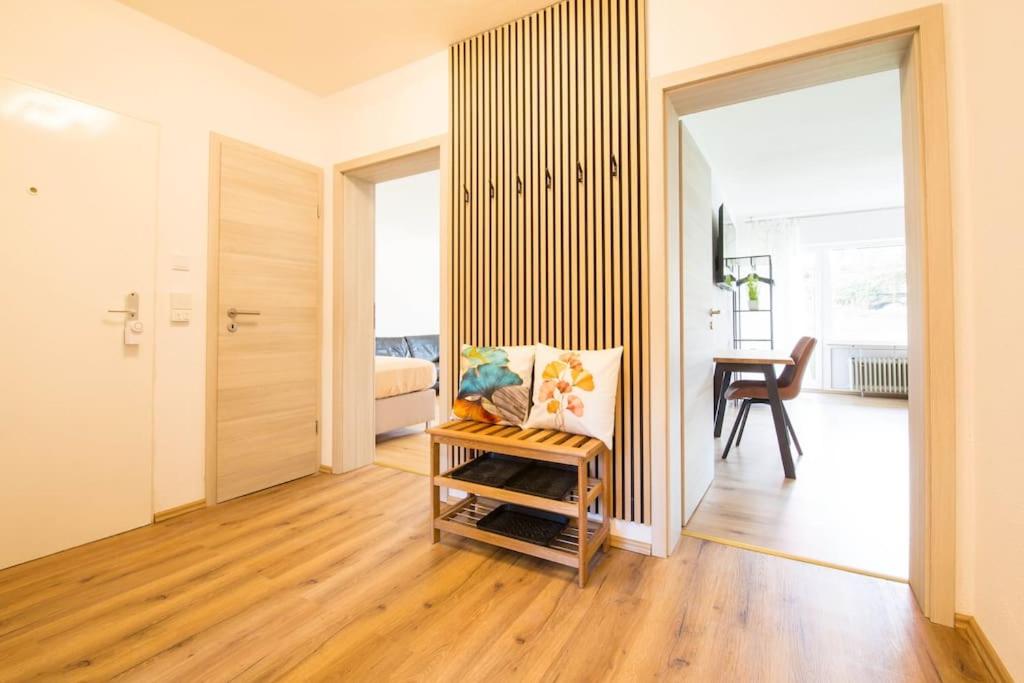 a living room with a chair and a desk in a room at Homefeeling Apartment am Eisweiher Park in Pirmasens