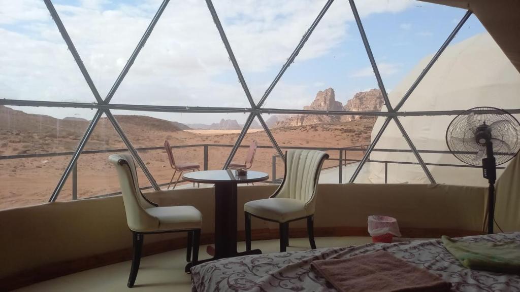 a room with a view of the desert from a window at Al Raha Luxury Camp in Wadi Rum