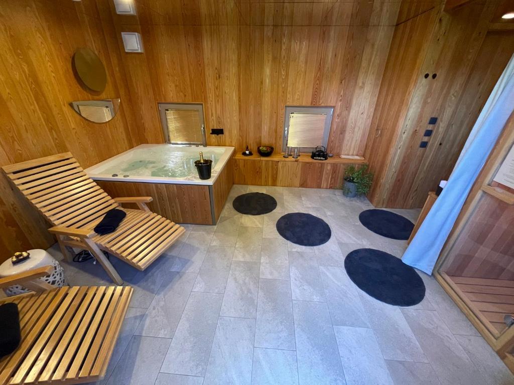 a large bathroom with a tub and a chair at BREZA mobile house BIG BERRY in Metlika