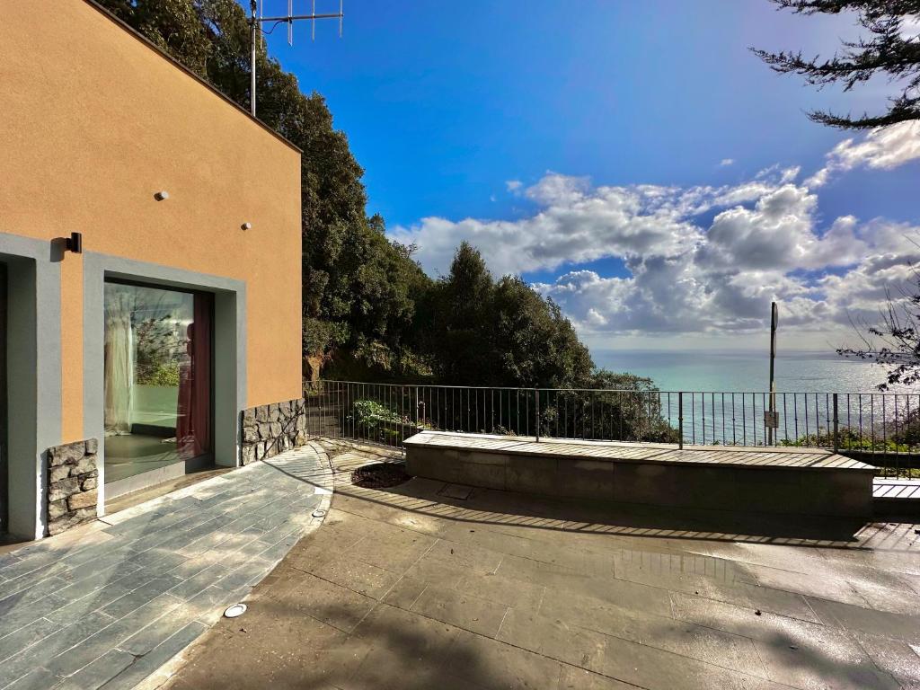 a house with a balcony with a view of the ocean at Cinque Terre Room Rental SULLA VIA in La Spezia
