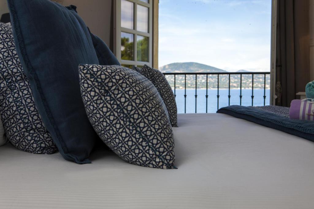 Un grupo de almohadas en una cama con vistas en La Bastide d'Antoine en Saint-Tropez