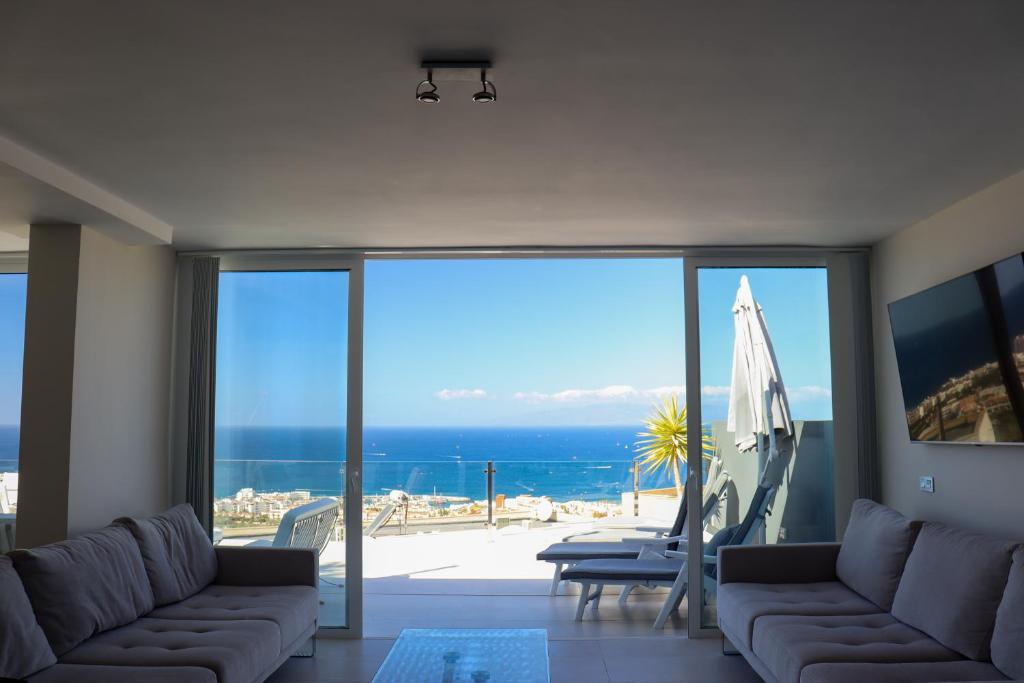a living room with a view of the ocean at Azure Sky Villa - Panoramic ocean view, luxury, San Eugenio in Adeje