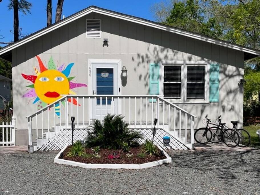 a house with a painting of a sun on it at Location, location, location! in Ocean Isle Beach