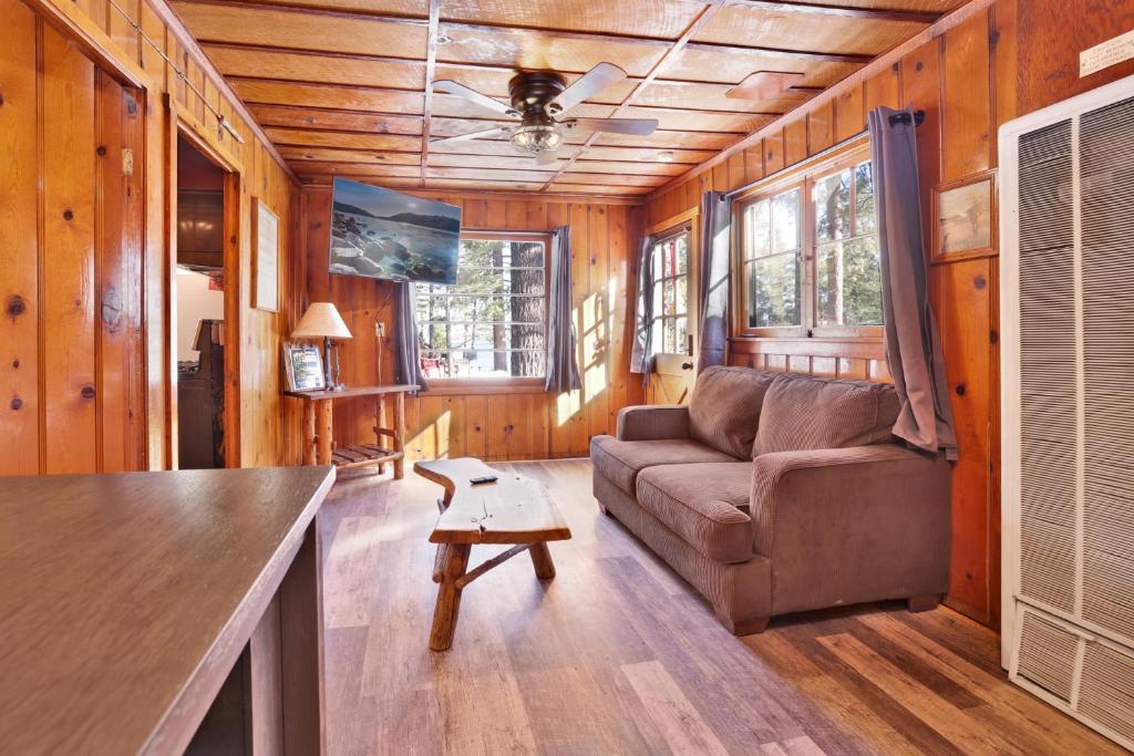 a living room with a couch and a table at Little Pines Couples Lakeside Cabin by Big Bear Vacations in Big Bear Lake