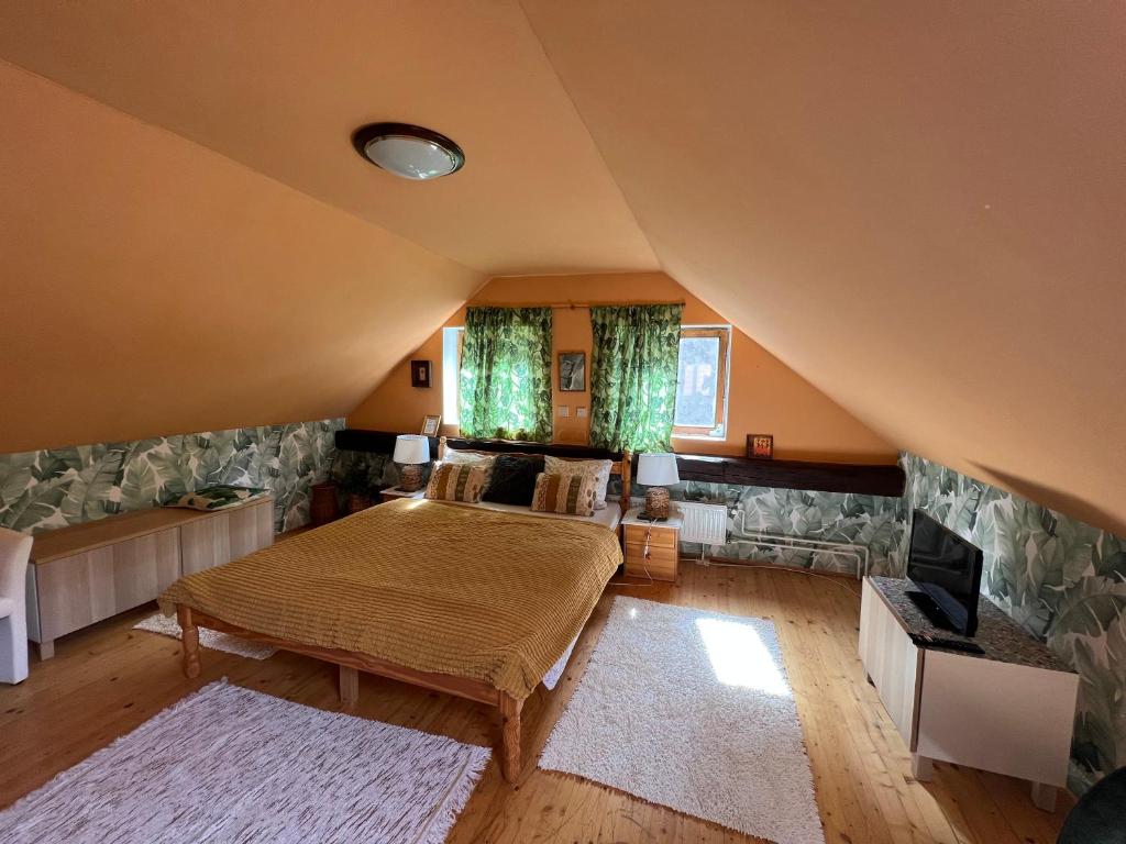 a bedroom with a large bed in a attic at LOFT Natalya Gold in Český Krumlov