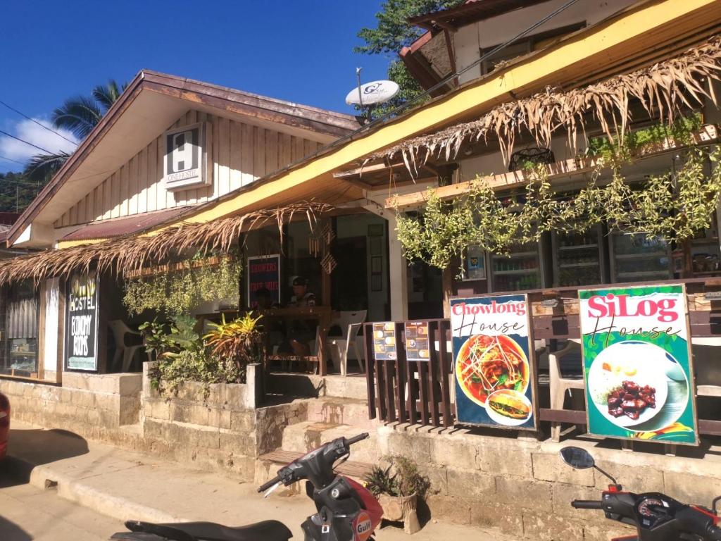 a restaurant with motorcycles parked in front of it at One Hostel - El Nido in El Nido