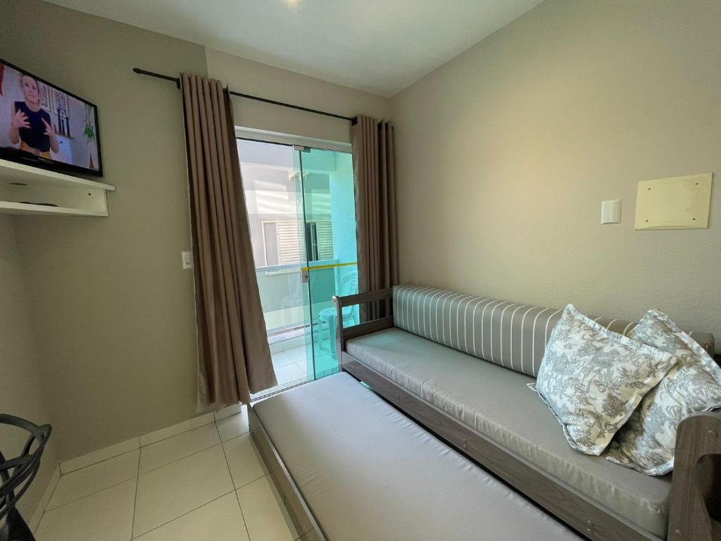a living room with a couch and a window at Residencial Alianza - Departamento de 1 habitación 204 in Bombinhas