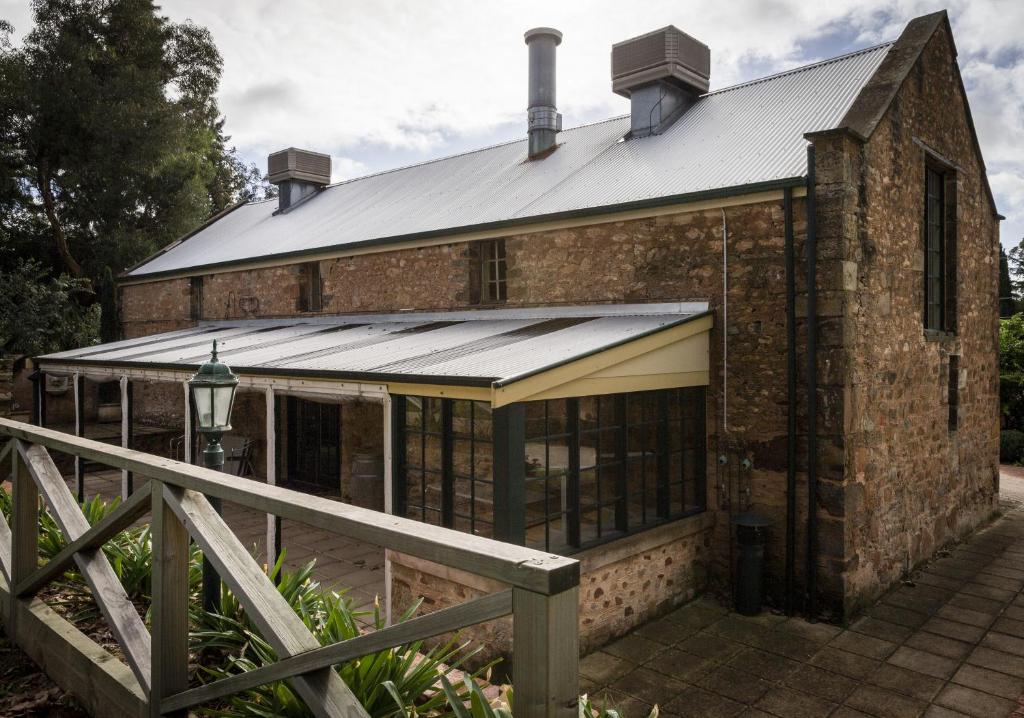 an old brick building with a metal roof at The Rising Sun Hotel in Auburn