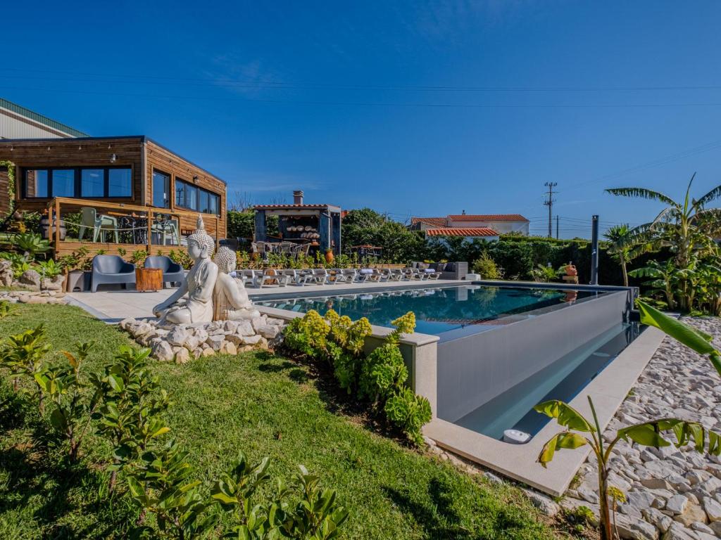 a backyard with a swimming pool and a house at Villas Pomar do Moinho in Usseira