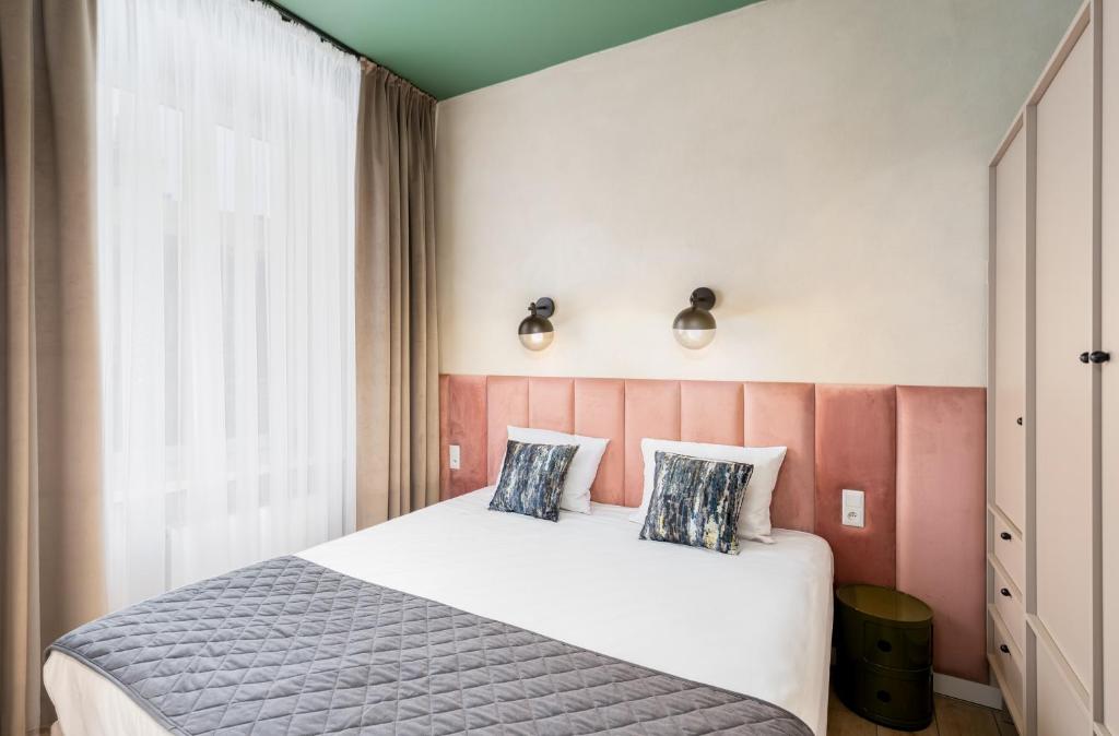a bedroom with a large bed and a window at 1898 Parkside Boutique Residence in Krakow