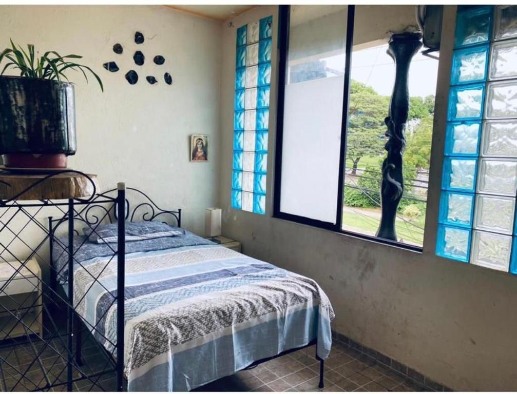 a bedroom with a bed and a window at Art life in Santa Cruz de la Sierra