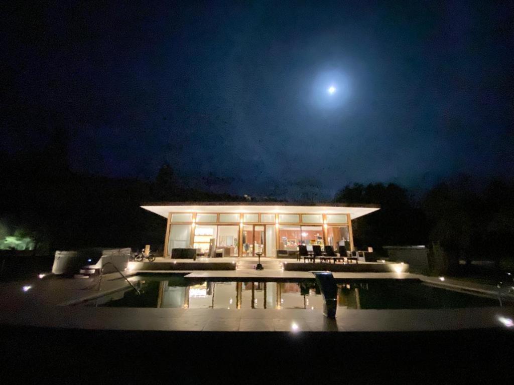 un edificio de noche con la luna en el cielo en Casa de campo, en Valdivia