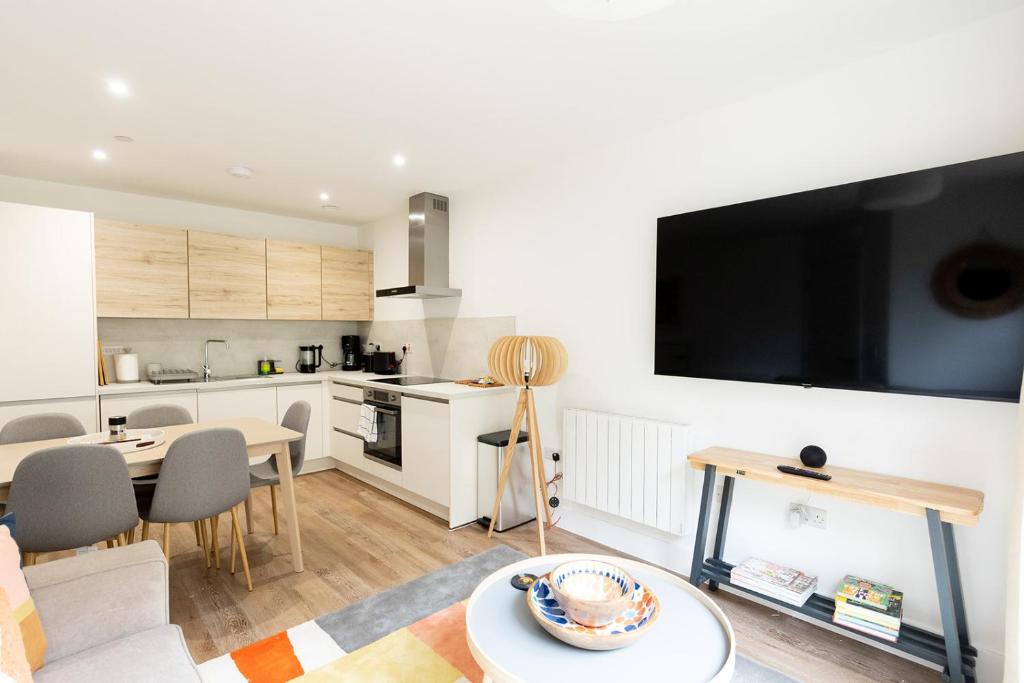 Una cocina y una sala de estar con un televisor de pantalla plana grande. en PAPER MILL - Experience the city and nature side of this stay!, en Sheffield