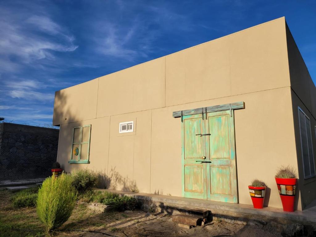 a building with a colorful door on the side of it at CASA PARA 10 PERSONAS, CAFAYATE in Cafayate