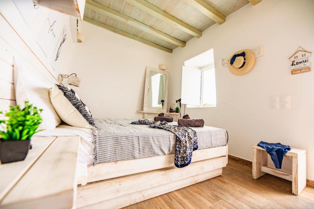 a bedroom with a bed and a mirror on the wall at Opus studio in Agios Stefanos